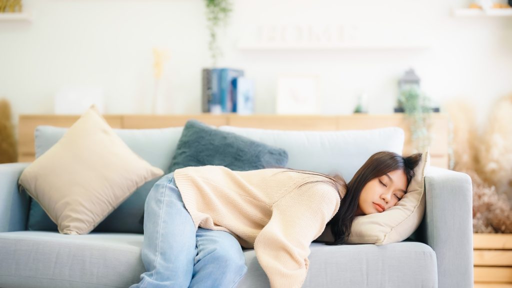 Asian,Woman,Resting,At,Home,On,Couch,,Feeling,Exhausted,After